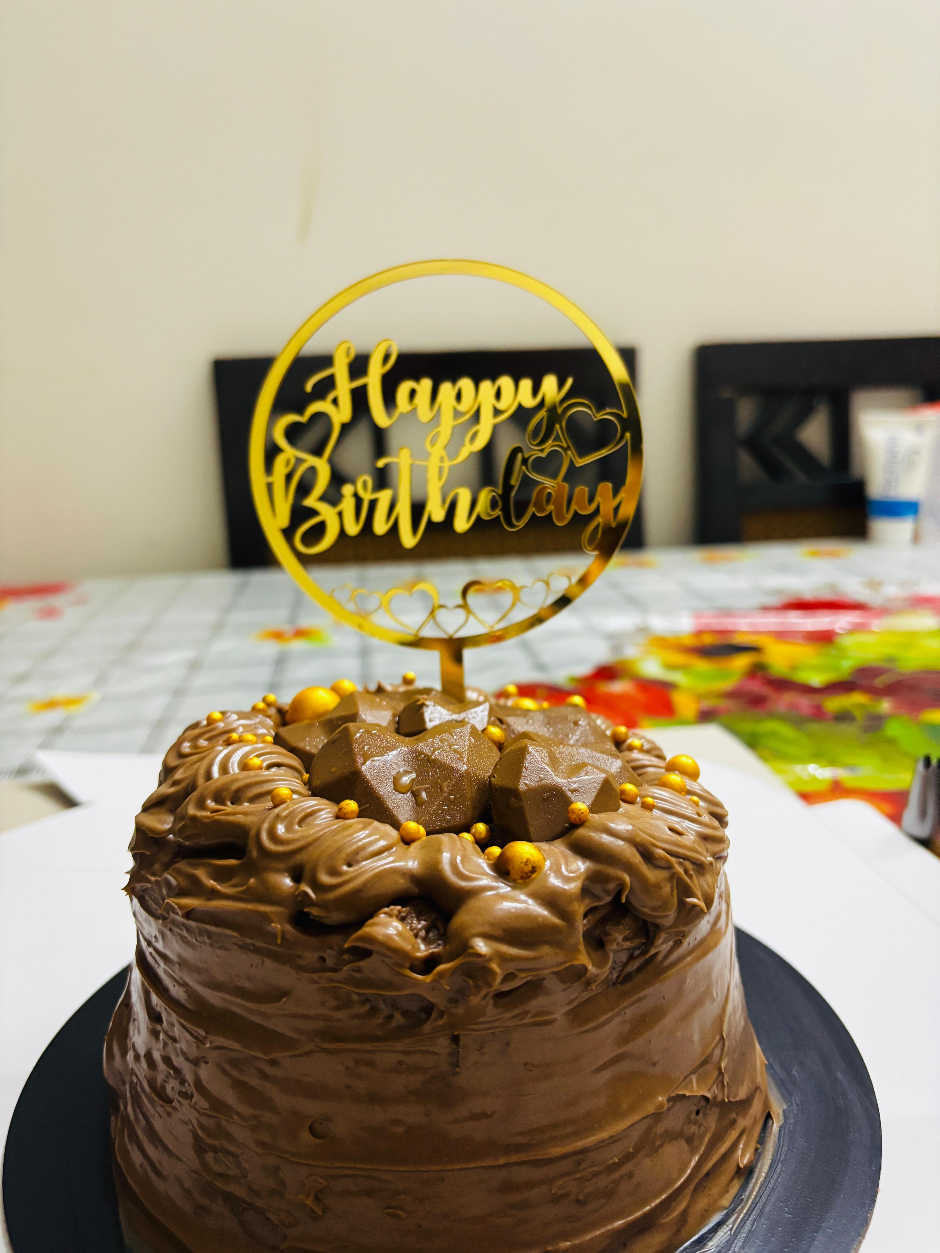 Chocolate birthday cake with gold topper